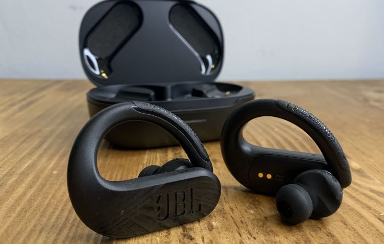 Pair of sports earphones and case on a table