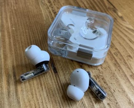 Pair of wireless earphones and case on a table