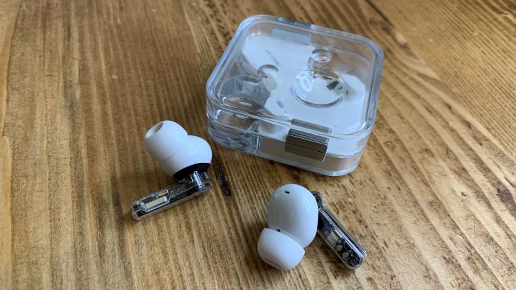 Pair of wireless earphones and case on a table