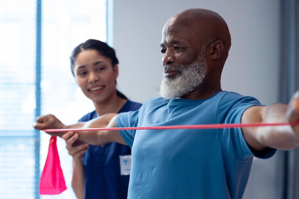 elderly man performing resistance band exercise
