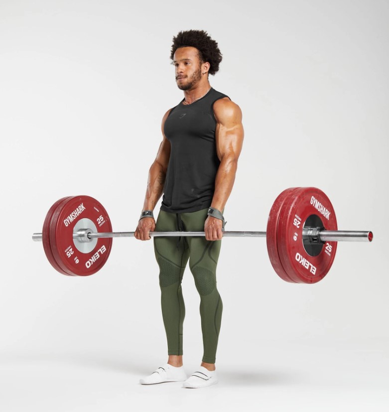 Man in compression tights lifting a barbell