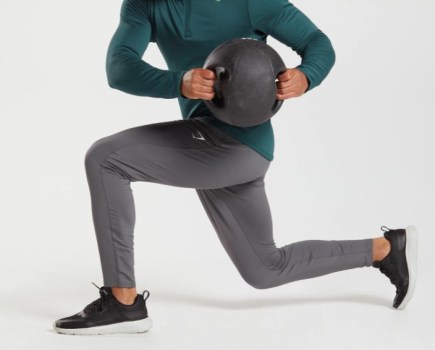 Shot of lower torso of a man wearing joggers exercising with a medicine ball