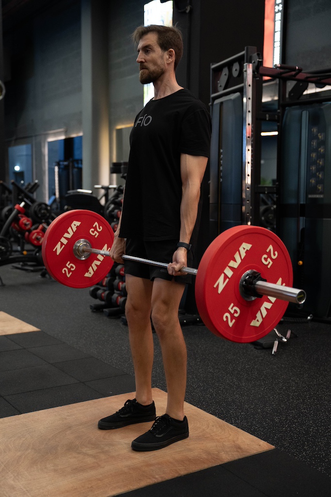 PT demonstrating how to perform a deadlift