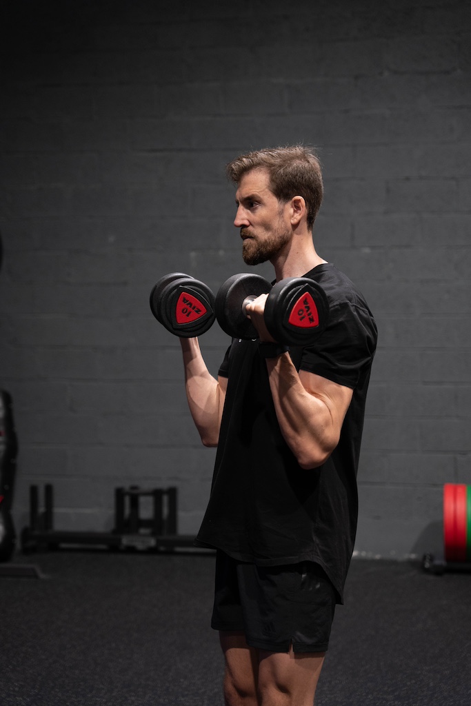 PT demonstrating how to perform a dumbbell curl