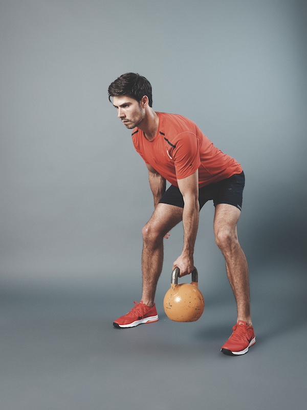man in fitness kit demonstrating how to do a kettlebell bent-over row 