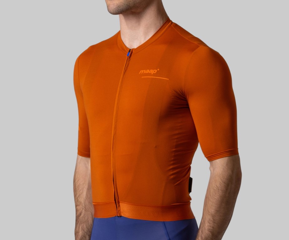 Model wearing Maap cycling top