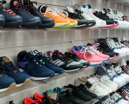 cushioned running shoes on shelves in sports shop