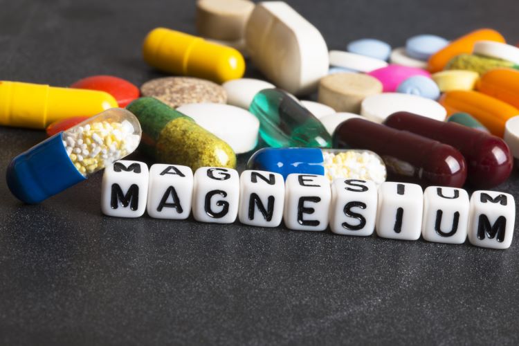 Selection of pills and supplements above the word 'magnesium'