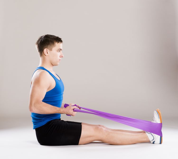 Man doing seated resistance band exercises