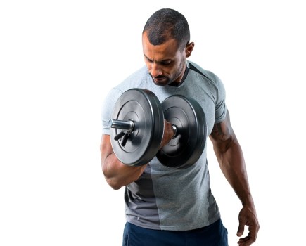 athletic man curling a dumbbell