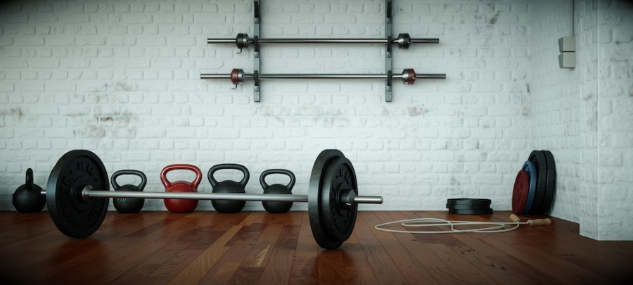 gym floor with barbell and kettlebells