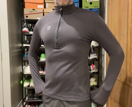 Mid-torso shot of a man wearing a running top