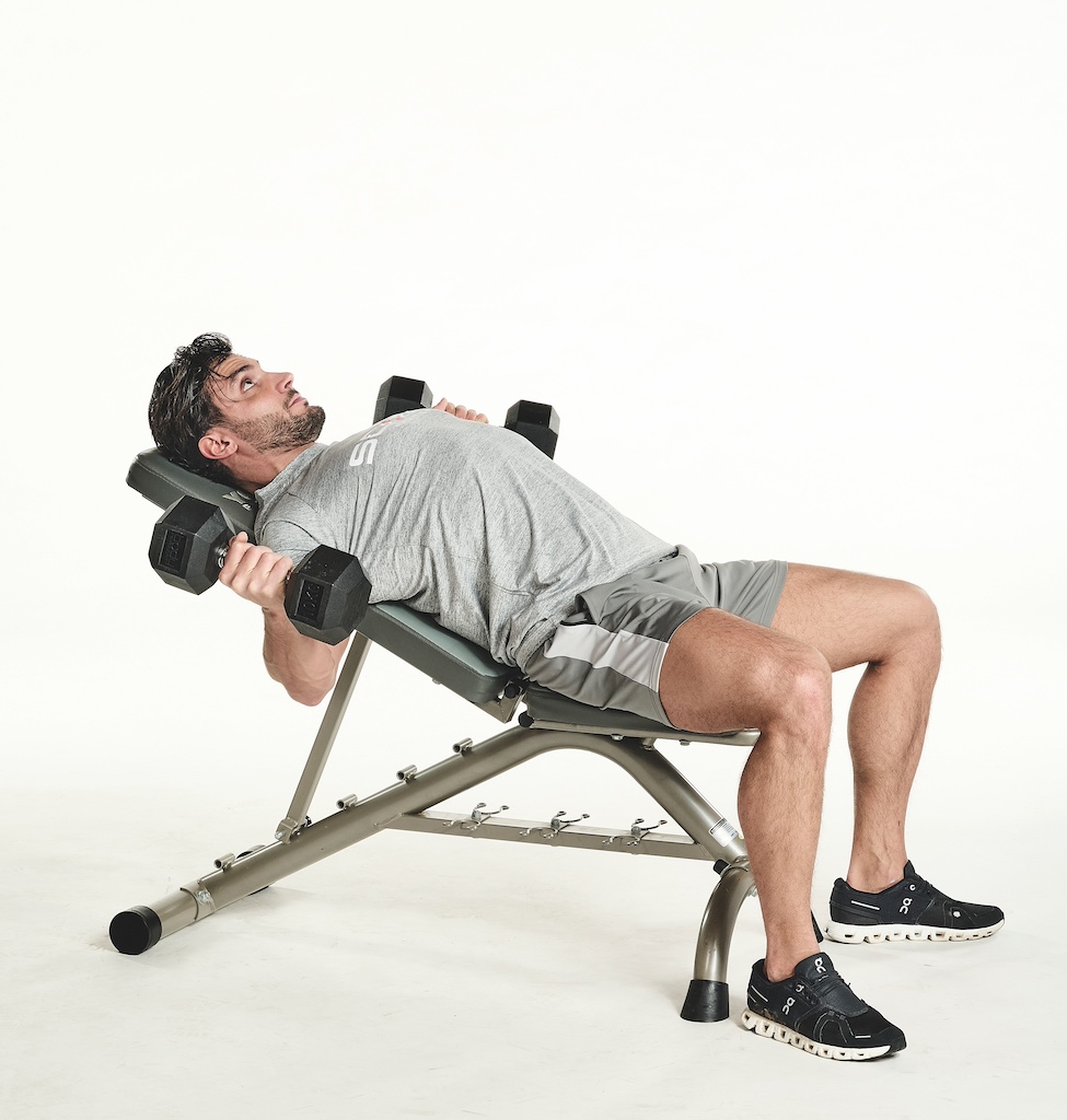 man performing dumbbell incline flye