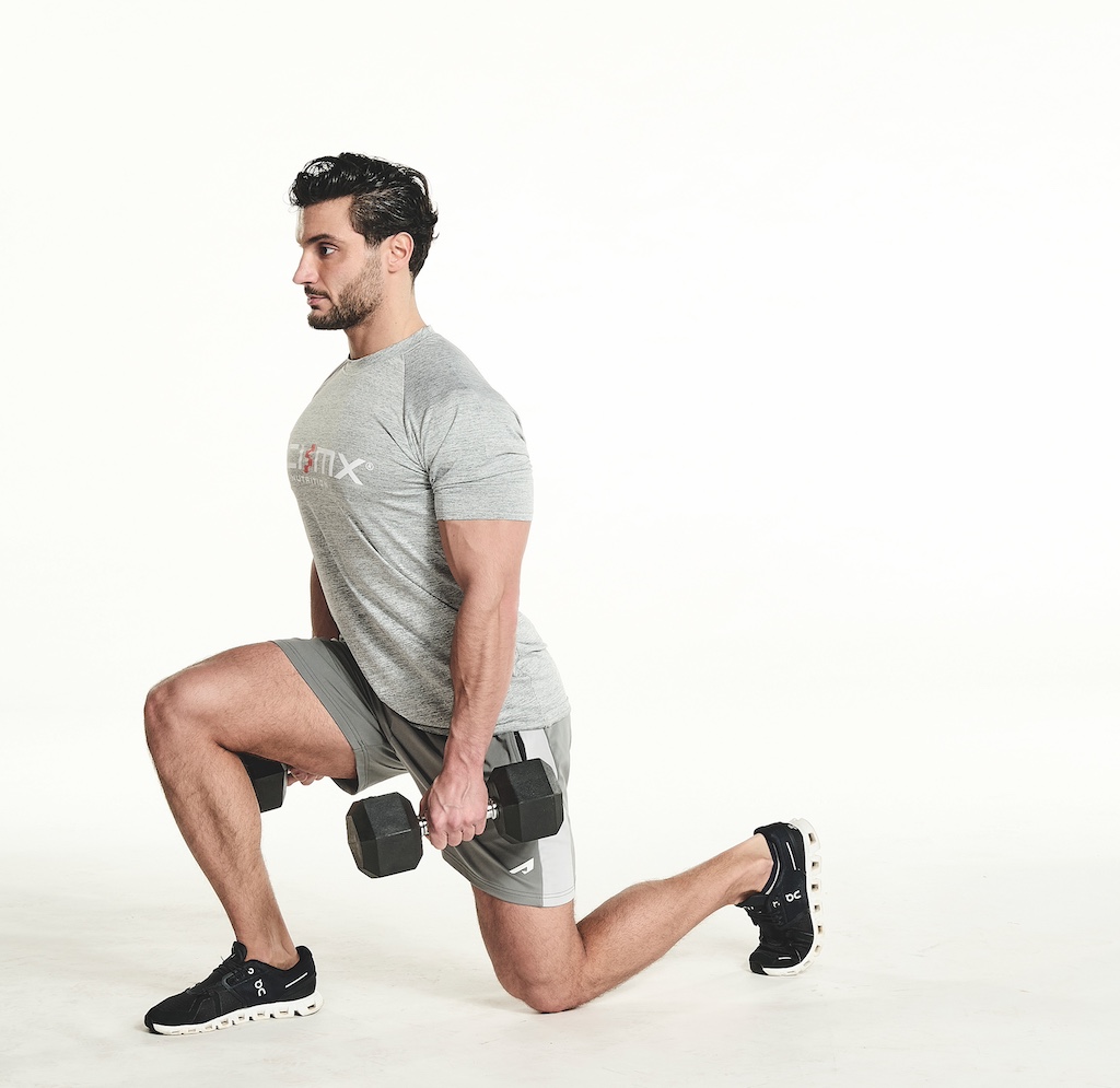 man performing dumbbell lunge exercise