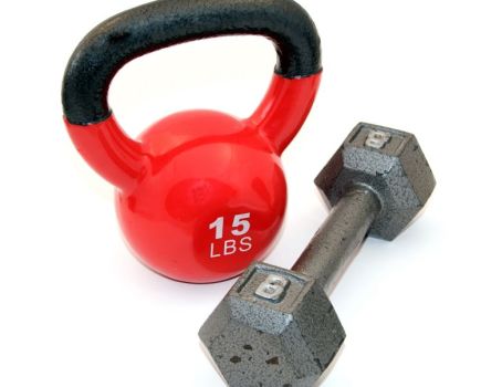 Red kettlebell and metal dumbbell