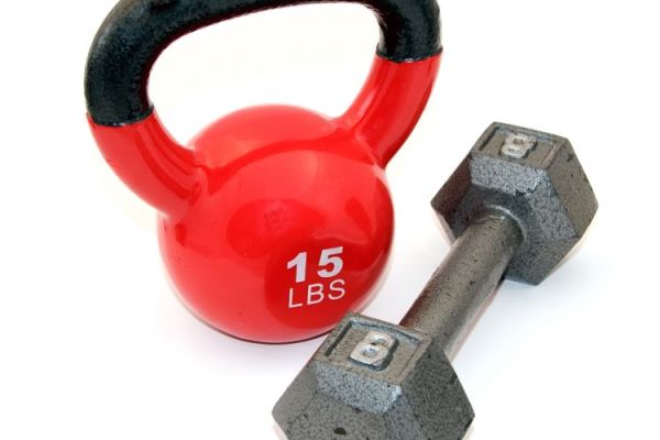 Red kettlebell and metal dumbbell
