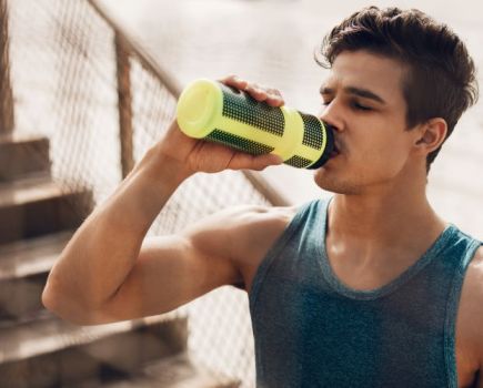 Close-up of a man drinking a sports drink