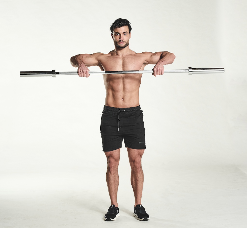 man performing barbell upright row as part of the busy man's training plan