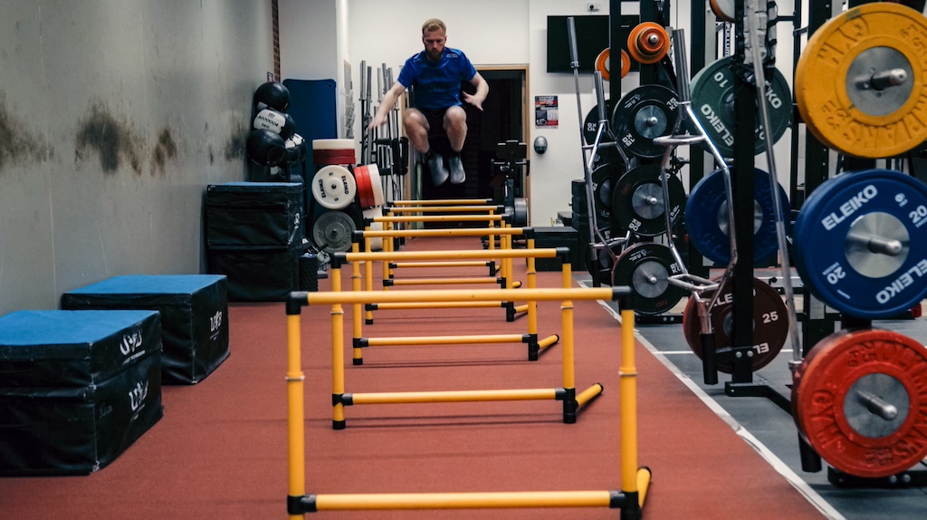 Joel Makin trains with hurdles in the gym