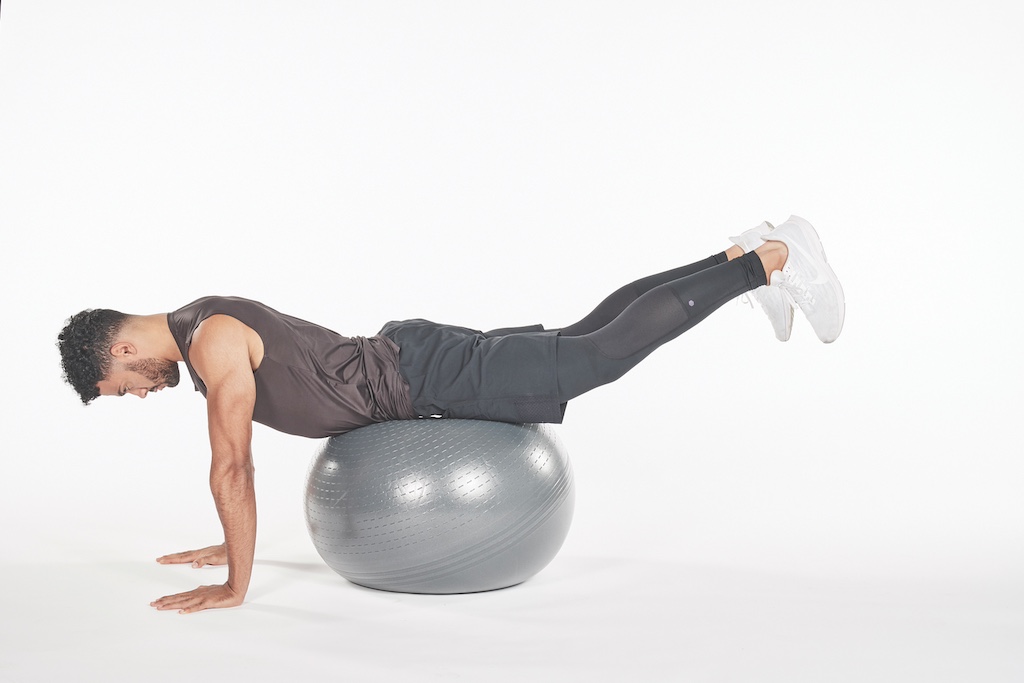 man demonstrating exercise ball hip extension exercise