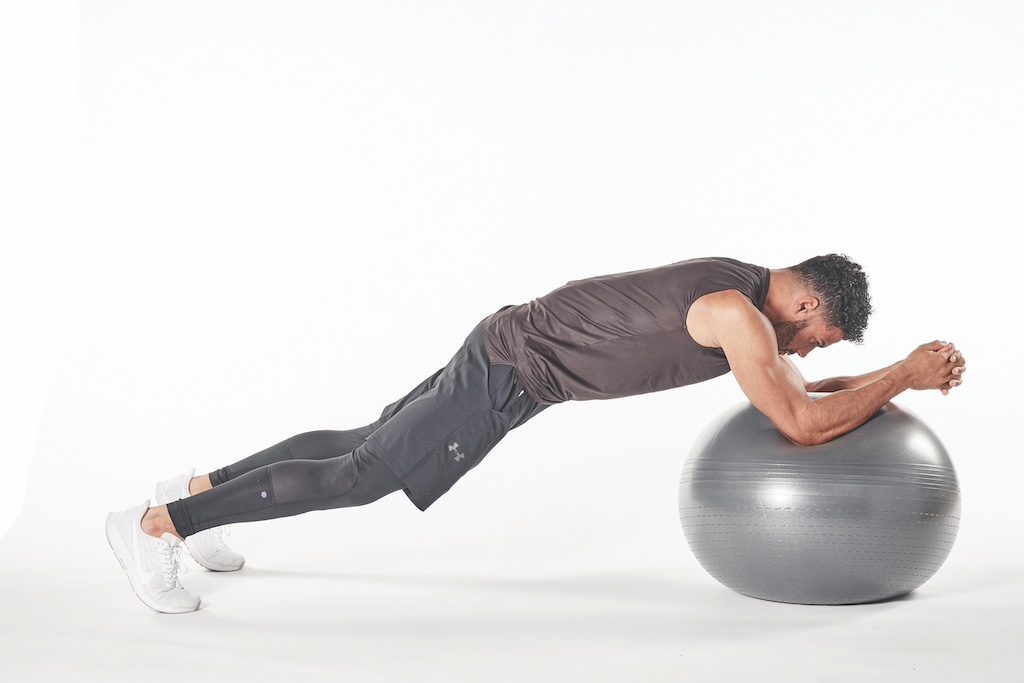 man demonstrating exercise ball roll-out