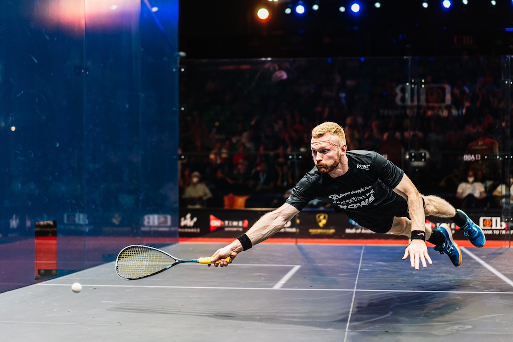 squash player Joel Makin dives at full stretch to reach the ball