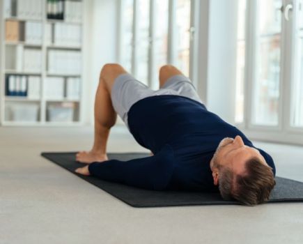 A man exercising at home on an exercise mat