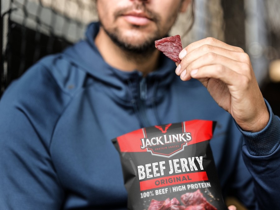 man eating Jack Link's beef jerky from the packet