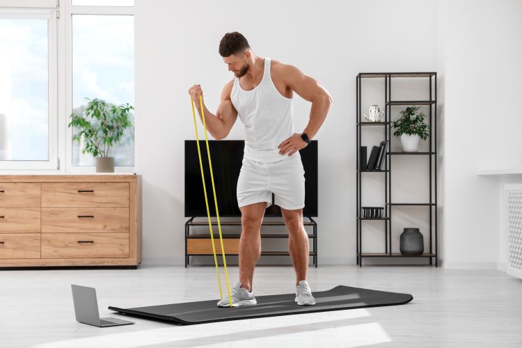 A man exercising with resistance bands at home