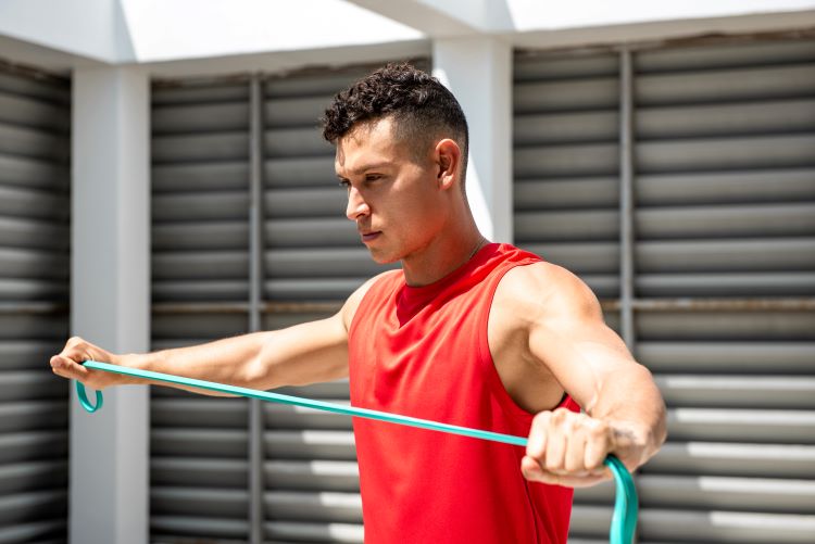 Man exercising with resistance band