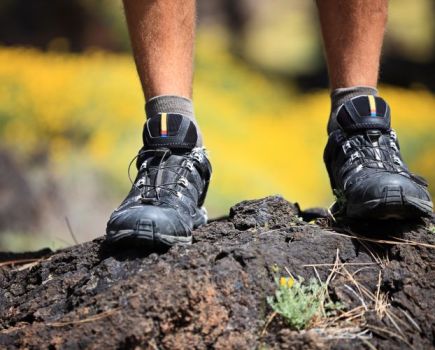 Close-up of a man's feet wearing hiking boots outdoors