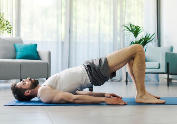 A man doing prone exercises on an exercise mat at home