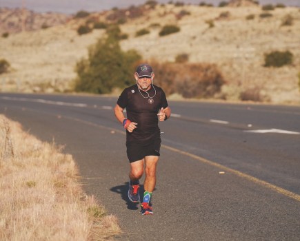 Ultrarunner Keith Boyd running along a road in Africa