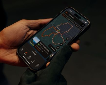 Close-up of a hand holding a phone with a map on the screen
