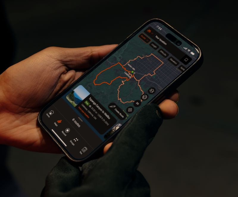 Close-up of a hand holding a phone with a map on the screen