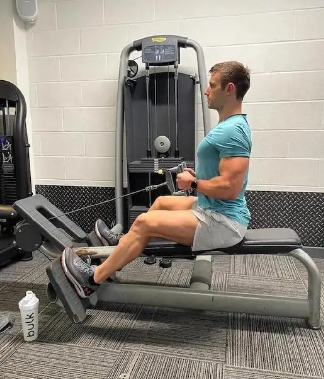 Man in a gym performing a seated row