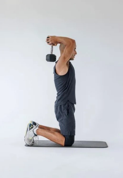 Man performing a dumbbell overhead extension