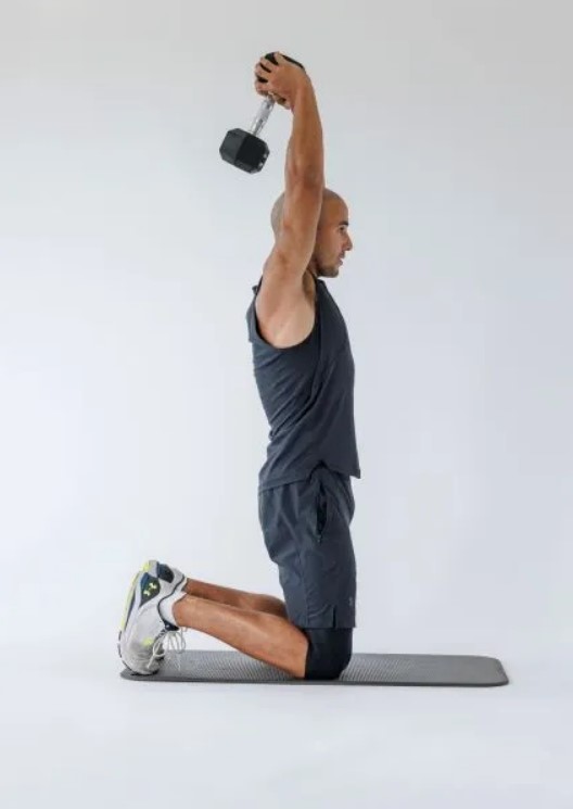 Man performing a dumbbell overhead extension