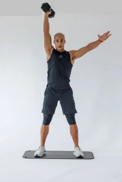 Man performing a dumbbell single-arm snatch