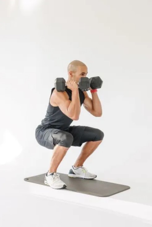 Man performing a dumbbell front squat