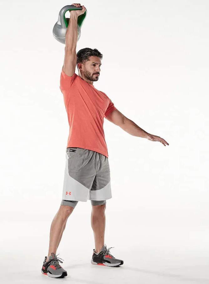 Man performing the kettlebell clean and press