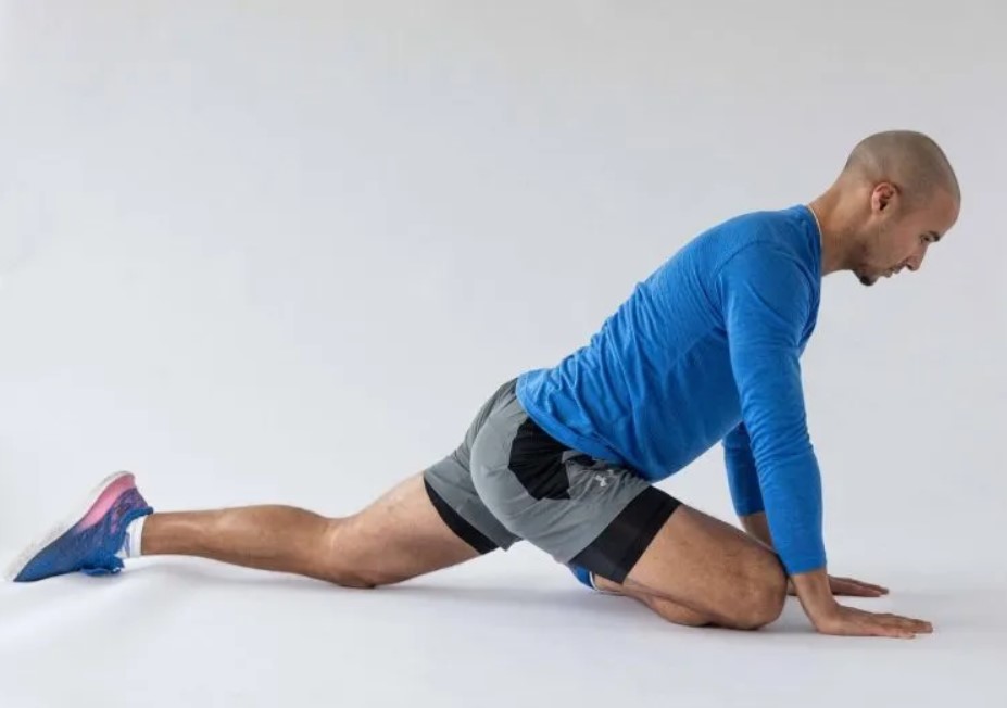 Man performing a pigeon stretch yoga pose