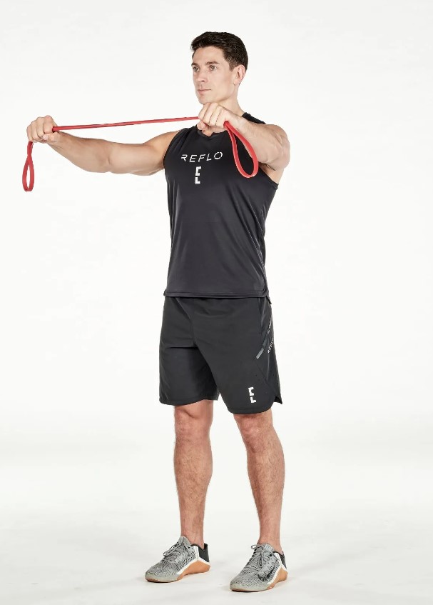 Man performing a resistance band pull-apart