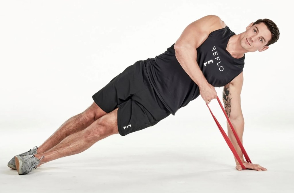 Man performing a resistance band side plank high pull