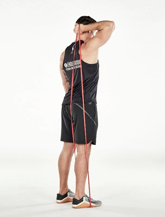 Man performing a resistance band single-arm triceps extension