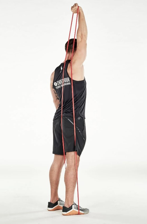 Man performing a resistance band single-arm triceps extension