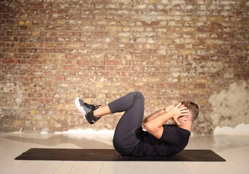 Man performing a V crunch exercise