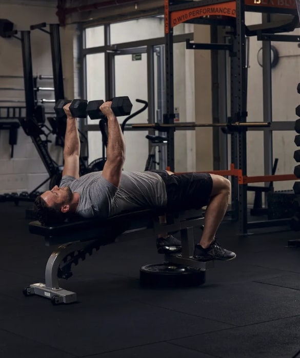 man performing decline dumbbell bench press
