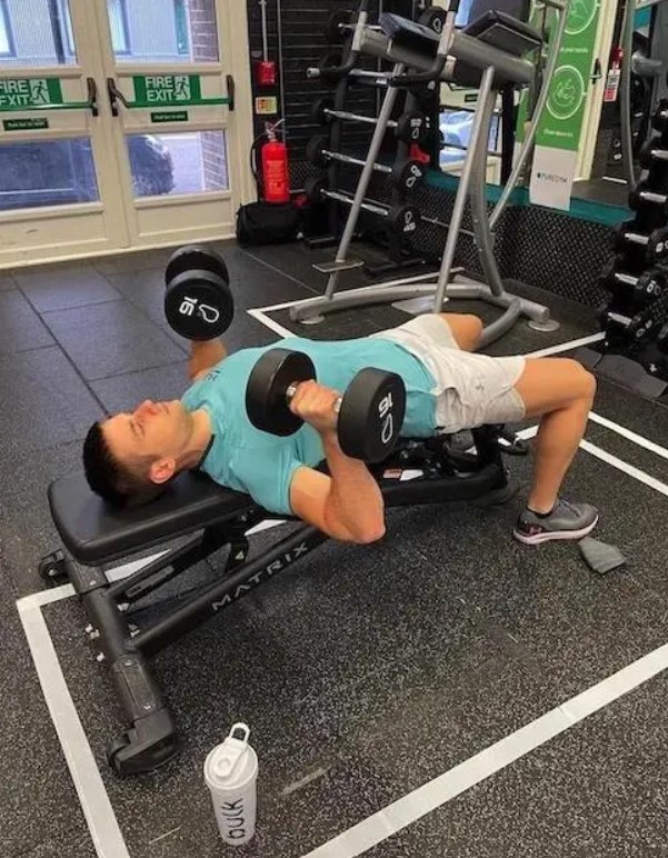 Man performing a dumbbell chest press