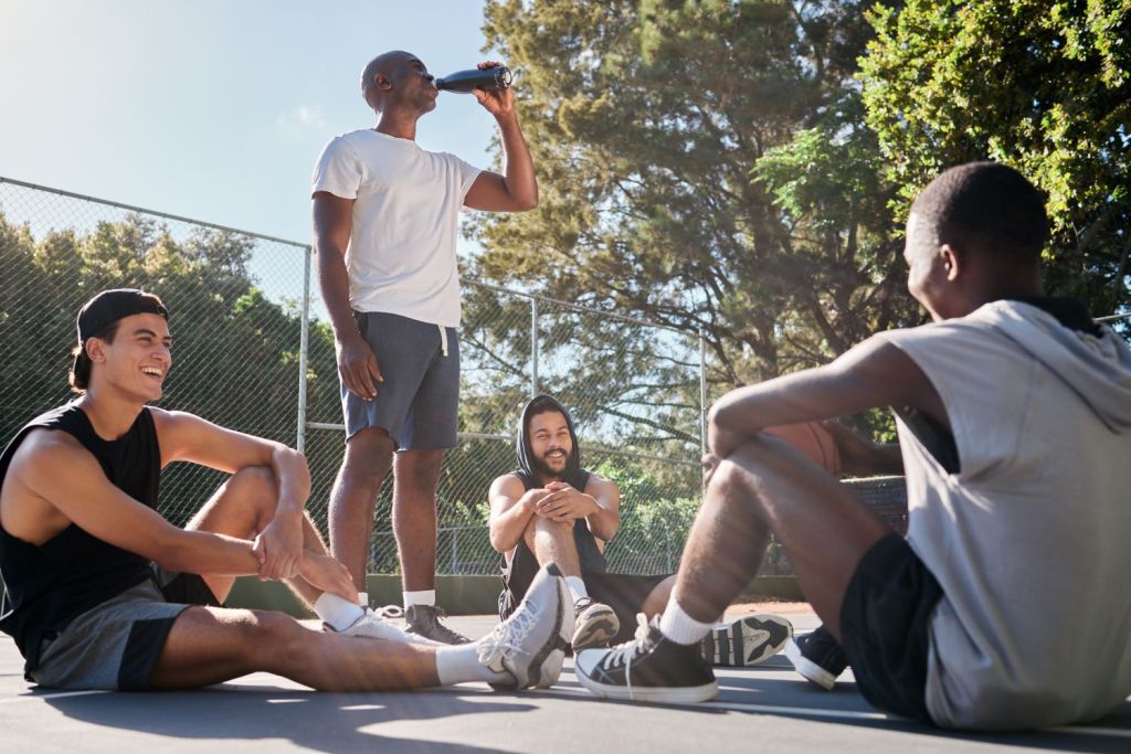 group of men socializing on a basketball court